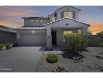 Beautiful two-story home featuring a tile roof, desert landscaping, and attached two-car garage at 9805 W Caron Dr, Peoria, AZ 85345