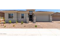 Charming single-Gathering home showcasing a two-car garage, landscaped yard, and a secure gated entrance at 11015 E Texas Ave, Mesa, AZ 85212