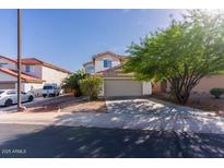 Charming two-story home featuring a spacious two-car garage and well-maintained front yard landscaping at 118 N 223Rd Ave, Buckeye, AZ 85326