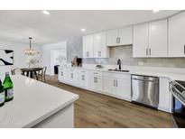Bright kitchen featuring white cabinets, quartz counters, stainless appliances, and tile backsplash at 132 W Orchid Ln, Chandler, AZ 85225