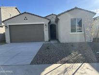 Charming single-story home featuring a neutral color palette, two car garage and desert landscaping at 17187 W Corrine Dr, Surprise, AZ 85388