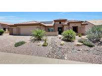 Inviting single-Gathering home featuring xeriscaping, desert plants, and a clay tile roof at 19745 N Mountain Sage Ln, Surprise, AZ 85374
