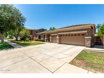 A single Gathering home featuring a neutral color palette, stone accents, and a three-car garage at 3006 E Lexington Ave, Gilbert, AZ 85234