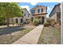 Inviting two-story home with a charming front yard and walkway at 3036 N Acacia Way, Buckeye, AZ 85396