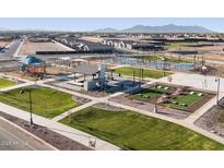 Beautiful community park featuring a playground, multiple sport courts, common area, and well-maintained landscaping at 37386 W San Sisto Ave, Maricopa, AZ 85138