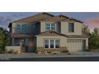 Charming two-story home with stone accents, a two-car garage, and well manicured landscaping at 5917 N 83Rd Ln, Glendale, AZ 85305