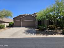 Charming single-story home featuring a well-maintained front yard and a spacious three-car garage at 7722 E Wolf Canyon St, Mesa, AZ 85207