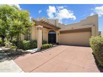 Inviting single-story home with a private courtyard, mature trees, and a two-car garage at 7955 E Chaparral Rd # 129, Scottsdale, AZ 85250