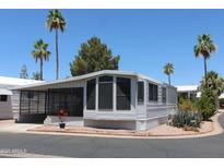Charming mobile home with screened in porch and desert landscaping for low maintenance living in a warm climate at 111 S Greenfield -- # 602, Mesa, AZ 85206