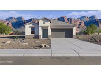 Charming single-story home with neutral tones, desert landscaping, and an attached two-car garage at 1373 S Vista Ave, Florence, AZ 85132
