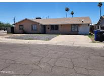 Charming single-story home featuring a xeriscaped front yard, driveway, and neutral-toned stucco exterior at 1602 N 57Th Ave, Phoenix, AZ 85035