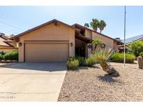 Charming single-story home with a two-car garage and desert landscaping at 18610 N 45Th Ave, Glendale, AZ 85308