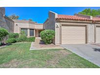 Charming single-story home featuring a tile roof, stucco exterior, and a well-maintained front yard with green grass at 19120 N 98Th Ln, Peoria, AZ 85382