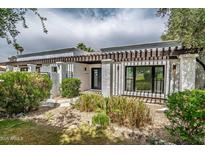 Inviting home exterior with a pergola-covered entrance, xeriscaping and modern design elements at 1925 E Lane Ave, Phoenix, AZ 85020