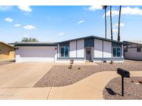 Charming single-story home with a well-manicured front yard and an attached two-car garage at 2706 W Isabella Ave, Mesa, AZ 85202