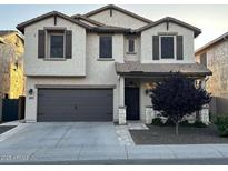Charming two-story stucco home with a two-car garage and well-maintained front yard at 28306 N 25Th Dl, Phoenix, AZ 85085