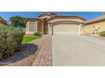 Charming single-story home featuring a two-car garage and a well-maintained landscaped front yard at 29049 N Coal Ave, San Tan Valley, AZ 85143