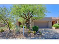 Charming desert home with mature trees, cacti, and low-maintenance landscaping at 32710 N 71St St, Scottsdale, AZ 85266