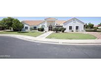 Charming single-story home boasts a well-maintained lawn and welcoming facade at 3314 E Draper Cir, Mesa, AZ 85213