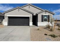 Charming single-story home with a two-car garage and low-maintenance desert landscaping at 470 W Freedom St, Florence, AZ 85132