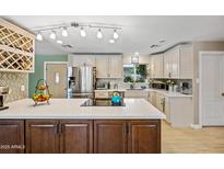 Bright kitchen featuring a center island, stainless steel appliances, and updated cabinets at 7246 E Virginia Ave, Scottsdale, AZ 85257