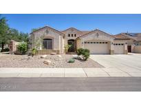 Charming single-story home featuring stucco siding, a tile roof, and a well-manicured front yard with desert landscaping at 8068 W Carlota Ln, Peoria, AZ 85383