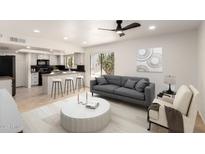 Bright living room with an open-concept kitchen and a modern gray sofa at 9645 W Kimberly Way, Peoria, AZ 85382