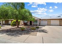Charming single-story home with a well-manicured desert landscaped front yard and a two-car garage at 9666 W Mountain View Rd # A, Peoria, AZ 85345