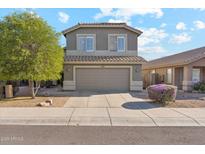 Charming two-story home with a well-manicured lawn and a two-car garage at 10252 E Butherus Dr, Scottsdale, AZ 85255