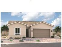 Charming single-story home featuring desert landscaping, a two-car garage, and a neutral color palette at 15818 W Miami St, Goodyear, AZ 85338
