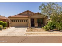 Charming single-story home featuring a well-maintained yard and a cozy front porch at 17038 W Mohave St, Goodyear, AZ 85338