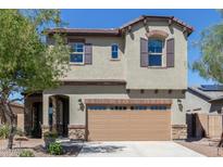 Beautiful two-story home featuring a brick-accented garage, desert landscaping, and shuttered windows at 17154 W Las Palmaritas Dr, Waddell, AZ 85355