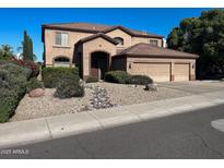 Charming two-story home with a well-manicured front yard and a three car garage at 17658 N 52Nd Pl, Scottsdale, AZ 85254