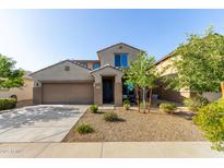 Two-story stucco home featuring a two-car garage, low maintenance landscaping, and covered entryway at 17946 W Via Del Sol --, Surprise, AZ 85387