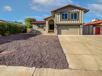 Charming two-story home with a well-maintained front yard and attached two-car garage at 1901 E Hearn Rd, Phoenix, AZ 85022