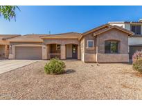Charming single-story home featuring a well-maintained front yard and a two-car garage at 19318 E Reins Rd, Queen Creek, AZ 85142