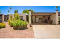 Charming home featuring desert landscaping and a convenient covered parking area with direct access to the front door at 1951 E Del Sur Dr, Tempe, AZ 85283