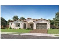 Beautiful single-story home with a well manicured lawn, desert landscaping, and a two car garage at 23098 E Nightingale Rd, Queen Creek, AZ 85142