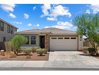 Charming single-story home with desert landscaping, tile roof and a two-car garage at 2410 S 124Th Dr, Avondale, AZ 85323