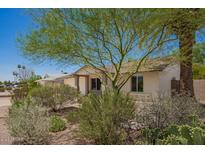 A charming single-story home boasting a well-kept yard with mature landscaping and a neutral color palette at 5350 S River Dr, Tempe, AZ 85283