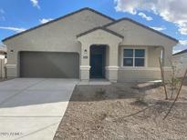 Inviting single-story home with a two-car garage and low-maintenance landscaping at 653 W Freedom St, Florence, AZ 85132