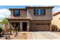 Charming two-story home with a well-maintained front yard and a two-car garage at 10830 W El Cortez Pl, Peoria, AZ 85383