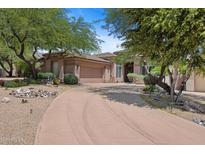 Beautiful, single-story home featuring mature desert landscaping and a neutral color scheme at 11081 E Betony Dr, Scottsdale, AZ 85255