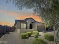 Charming single-story home featuring mature landscaping, a brick walkway, and an attached two-car garage at 24776 N 171St Ln, Surprise, AZ 85387