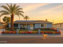 Charming single story home with desert landscaping, solar panels, and a friendly dog at 2718 W Montebello Ave, Phoenix, AZ 85017