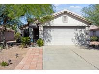 Charming single-story home featuring a two-car garage, desert landscaping, and a cozy covered entrance at 3534 N 106Th Ln, Avondale, AZ 85392