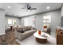 Comfortable living room with a tan sofa, modern decor, and a ceiling fan for a relaxed atmosphere at 3810 N Maryvale Pkwy # 2020, Phoenix, AZ 85031