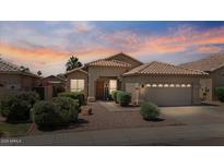 Charming single-story home with a tile roof, mature landscaping, and a welcoming front entrance at 4459 E Desert Wind Dr, Phoenix, AZ 85044