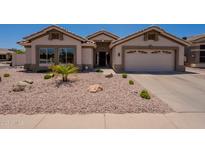 Inviting single-story home featuring a low-maintenance desert landscape and a two-car garage at 509 W Villa Rita Dr, Phoenix, AZ 85023