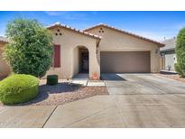 Charming single-story home featuring a two-car garage, stucco exterior, and a well-manicured front yard at 654 E Buckingham Ave, Gilbert, AZ 85297
